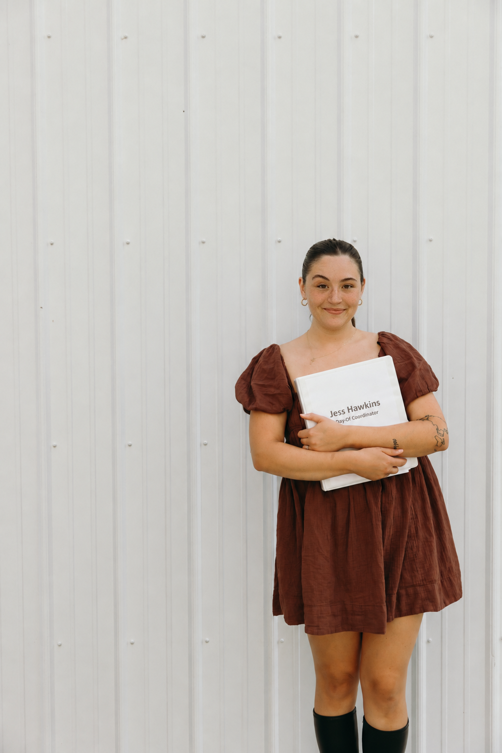Jessica Hawkins holding her day-of coordination folder.